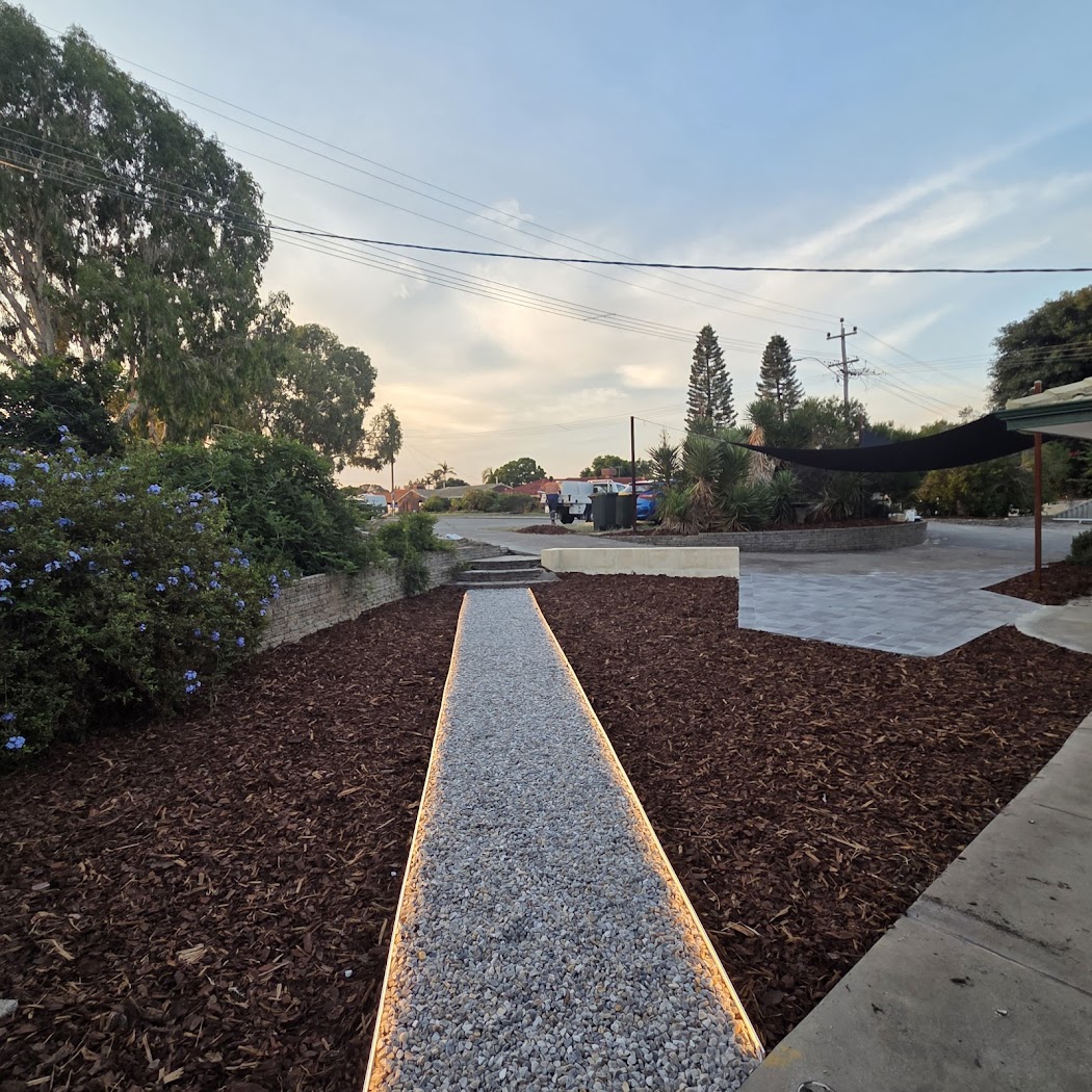 Landscaped garden path with feature lighting at dusk by Blue Vikings, Perth